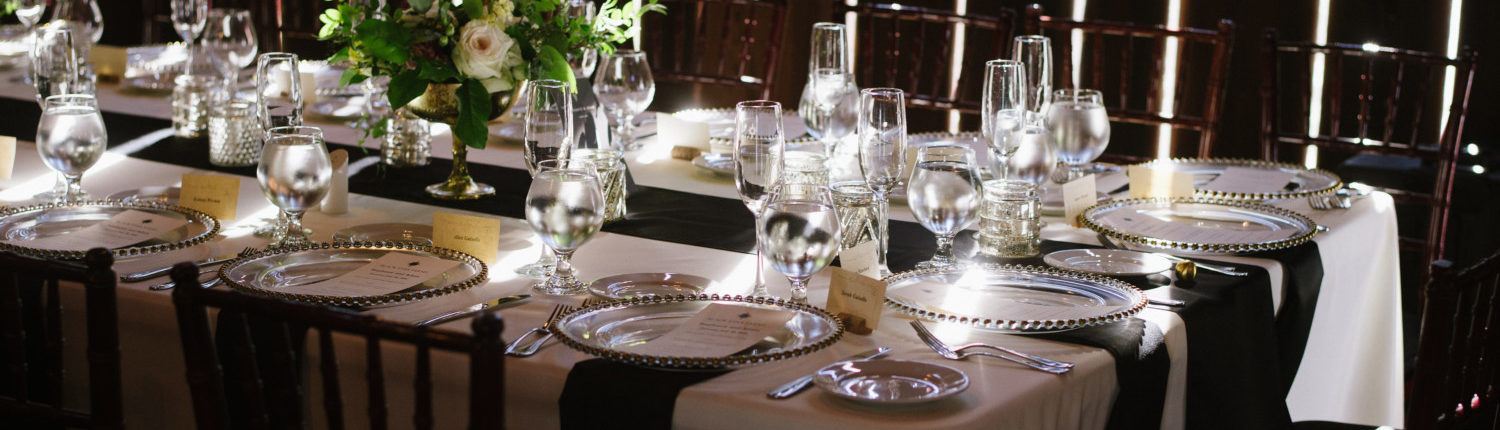 Close up of a wedding reception table with dramatic lighting in the Pegasus Barn.
