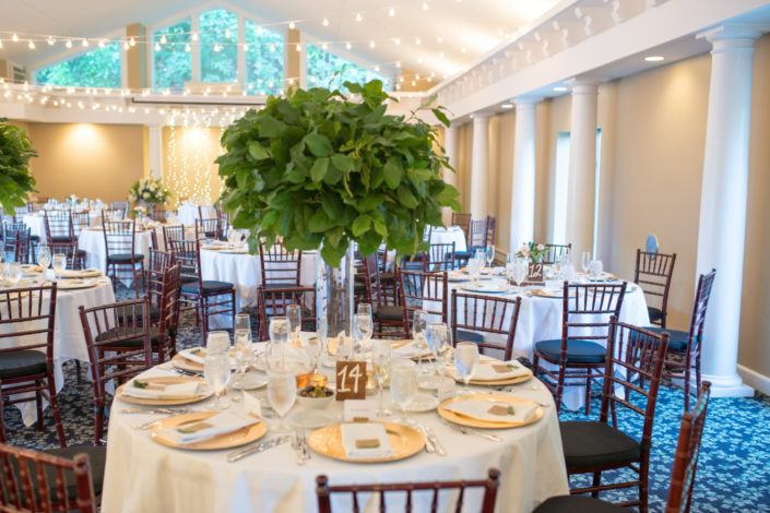 Round tables decorated for a wedding reception in the Aquarius Room at the Inn at Black Star Farms.