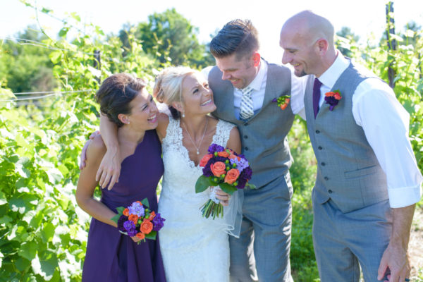 Bride with bridesmaid and two groomsmen in the vineyard at Black Star Farms Suttons Bay.