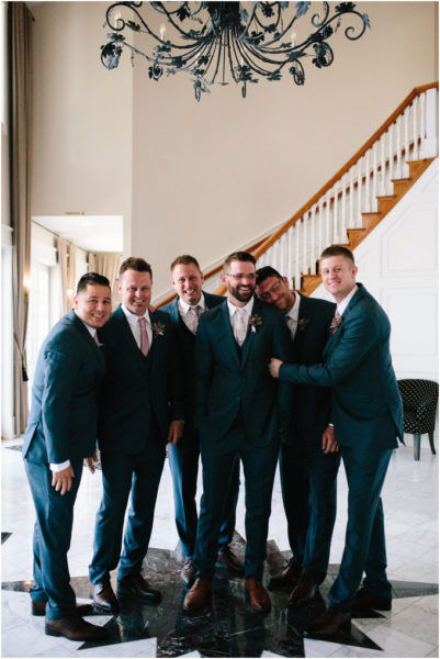 Groom and his groomsmen in the foyer of the Inn at Black Star Farms.