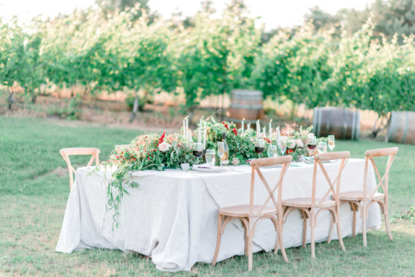 Lavishly set wedding party table in the vineyard at Black Star Farms Suttons Bay.