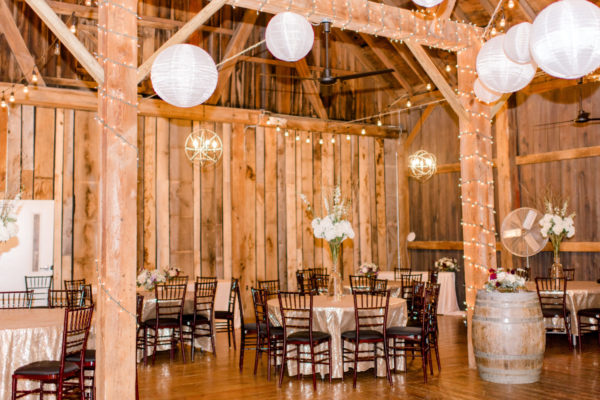 Decorated round tables for a wedding reception with Chinese lanterns in the Pegasus Barn.