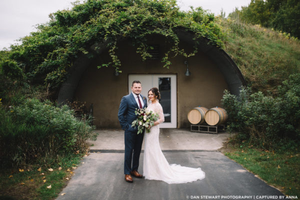 Wedding couple in front of the wine cave.