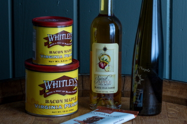 Black Star Farms Apple Brandy, Sirius Maple Dessert Wine, Whitley's Peanuts, and a chocolate bar.