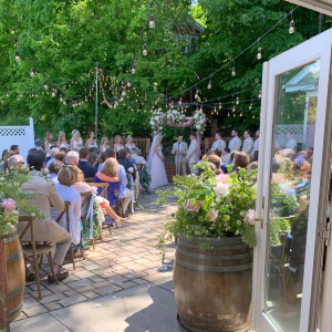 Small wedding ceremony on the stone patio off the Inn at Black Star Farms.