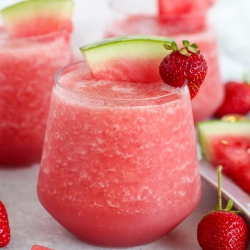 Example of Frose Fruit Slushies with strawberry and watermelon garnish.