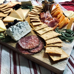 Charcuterie board with meat, cheese, and Black Star Farms house-made crackers.