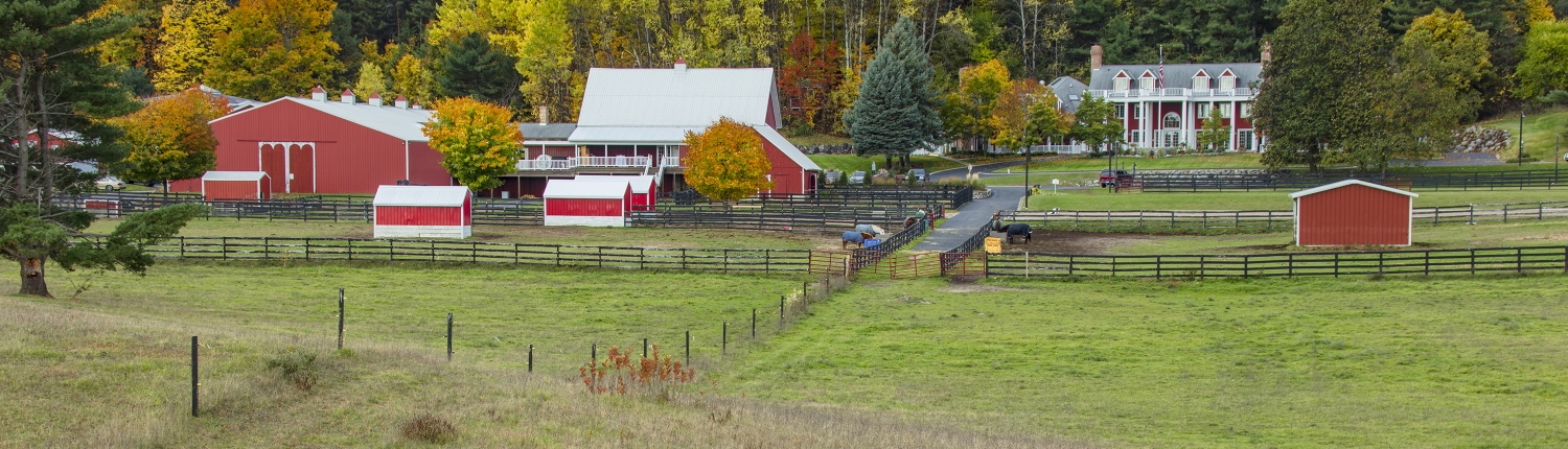 View of the Inn, horse paddocks, and barns in the fall.