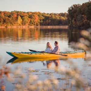 Couple kayaking during the fall as part of our Outdoor Adventure Package.
