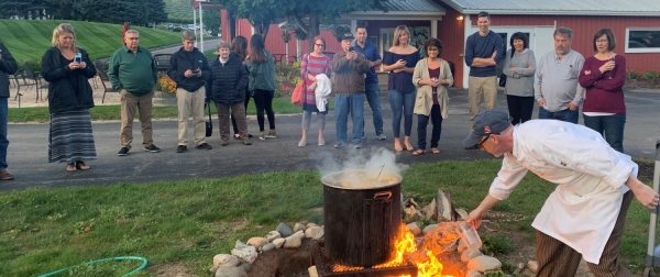 Lighting the fire for the boil over at the Great Lakes Fish Boil at the Hearth & Vine Cafe.