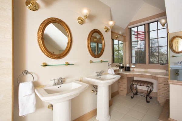 Bathroom with dual pedestal sinks and vanity in Diadem suite.