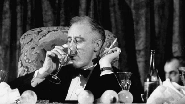 President Franklin Delano Roosevelt drinks a glass of wine.