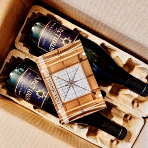 Bottle of wine in shipping box with card.