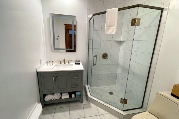Walk-in shower and vanity in the bathroom in the Rigel room.