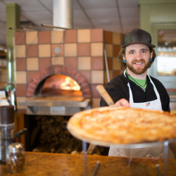 Serving a Pizza at Hearth Vine RM 250x250 1