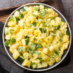 Scrambles eggs with green vegetables.
