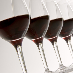 Four wine glasses with red wine.