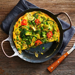 Vegetable frittata in a cast iron skillet.
