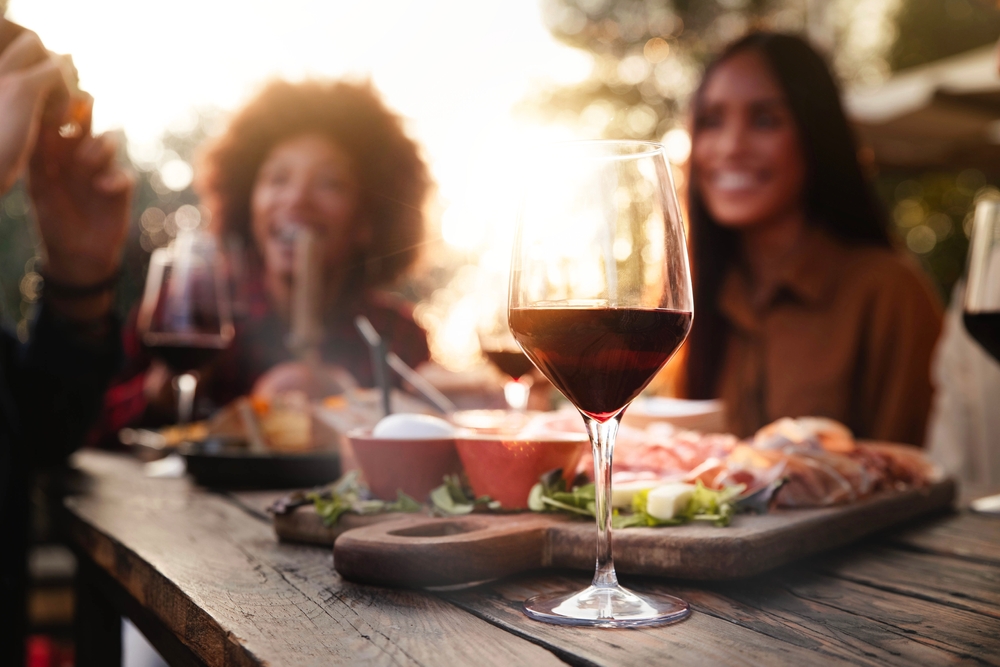 Friends drinking wine and enjoying food on the best Traverse City wine tours this fall