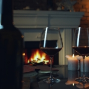 Glasses of red wine by the fireplace - a cozy winter wine tasting on the Leelanau Peninsula Wine Trail