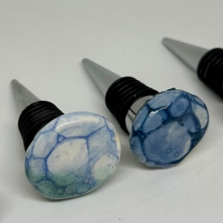 Two bubble glazed wine stoppers.