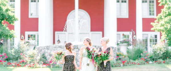 Bride and Bridesmain in front of our Inn - one of the best wedding venues in Traverse City