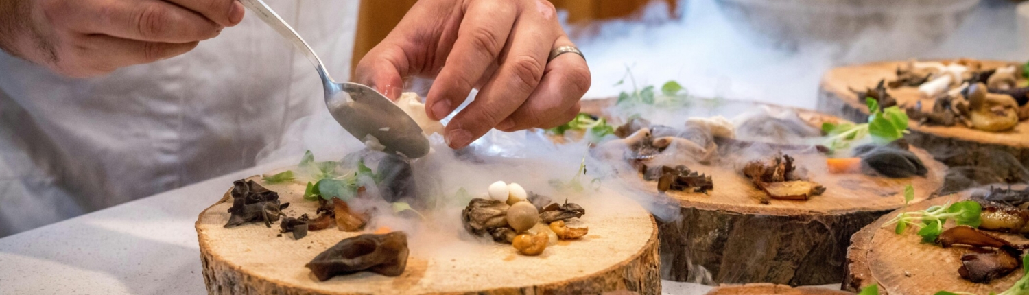 Chef plating a wild mushroom dish.