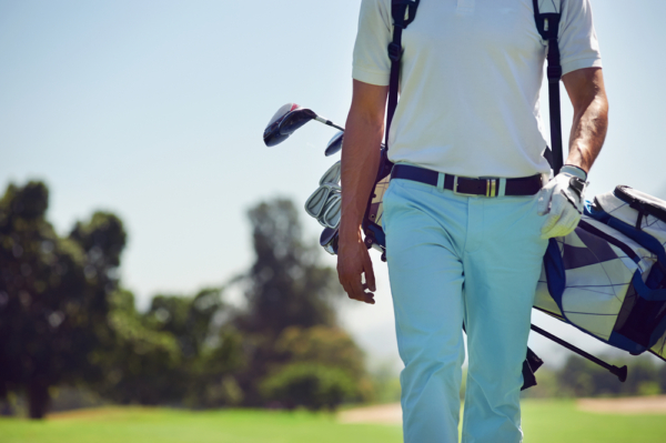 Man walking with clubs on one of the top golf courses near Traverse City, Michigan