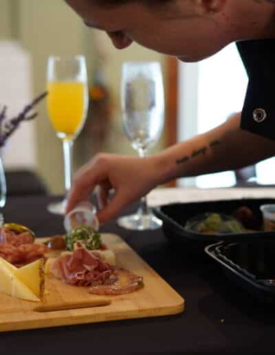 Chef preparing a charcuterie board.