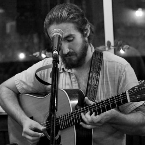 Nick Veine playing the guitar.