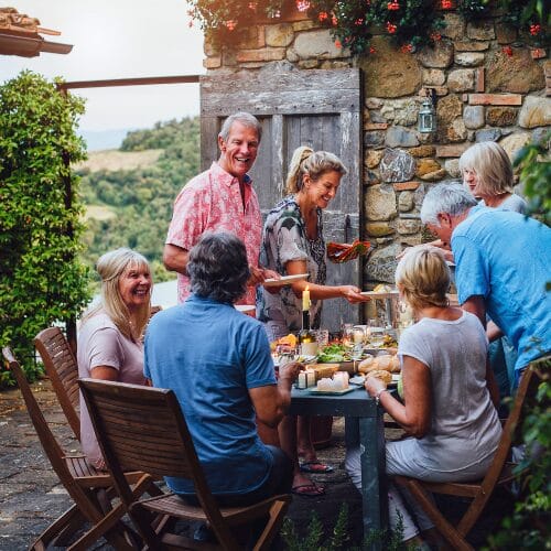 People enjoying dinner outside in Tuscany, Italy.
