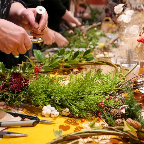 WINE & WORKSHOPS 1 People making holiday wreaths