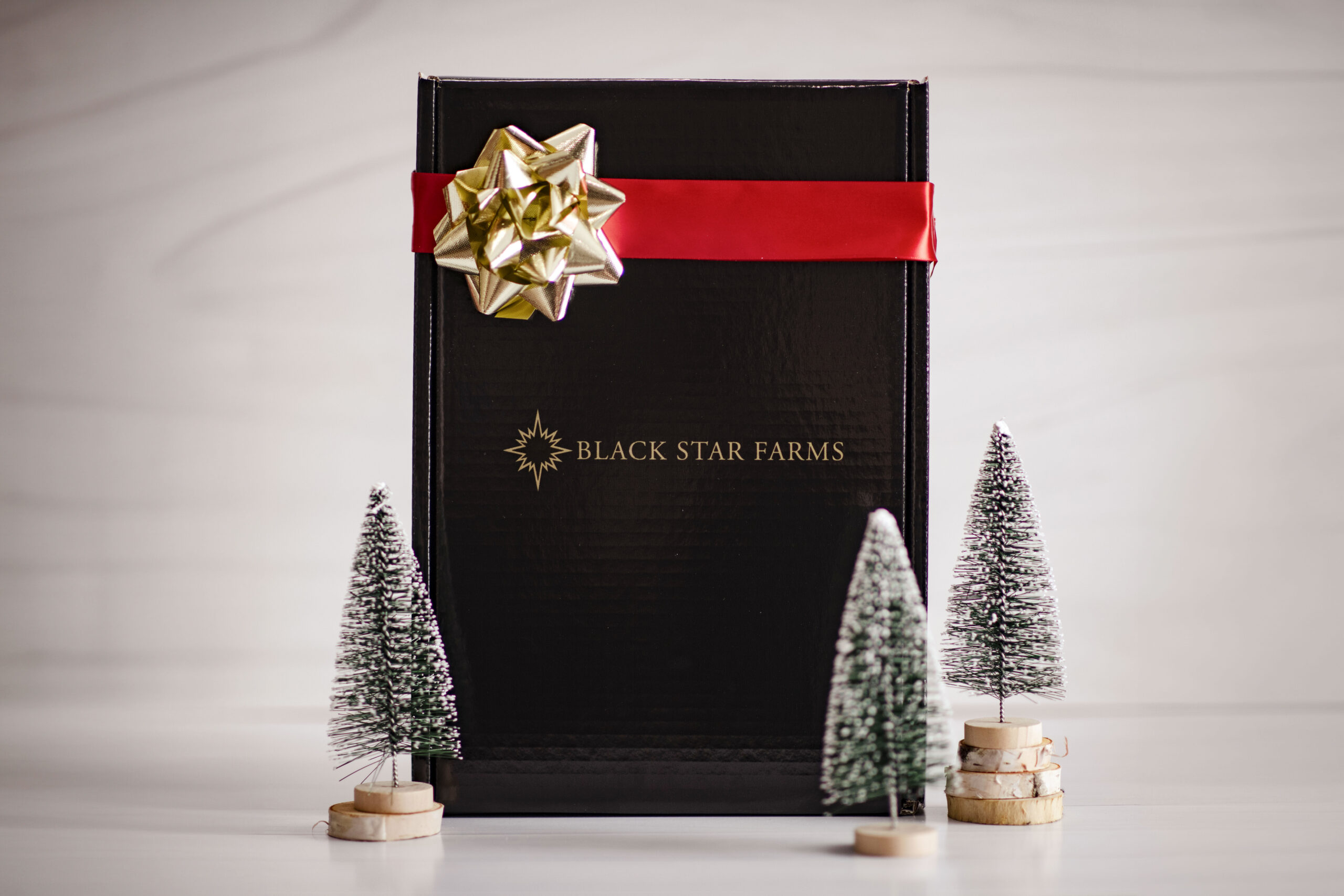 Corporate Gifting 2 Chocolate tart topped with almonds on a plate.