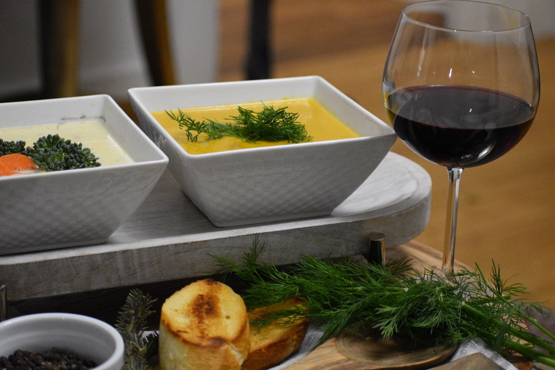 A white plate displaying a sunny-side-up egg accompanied by a vibrant mix of assorted vegetables.