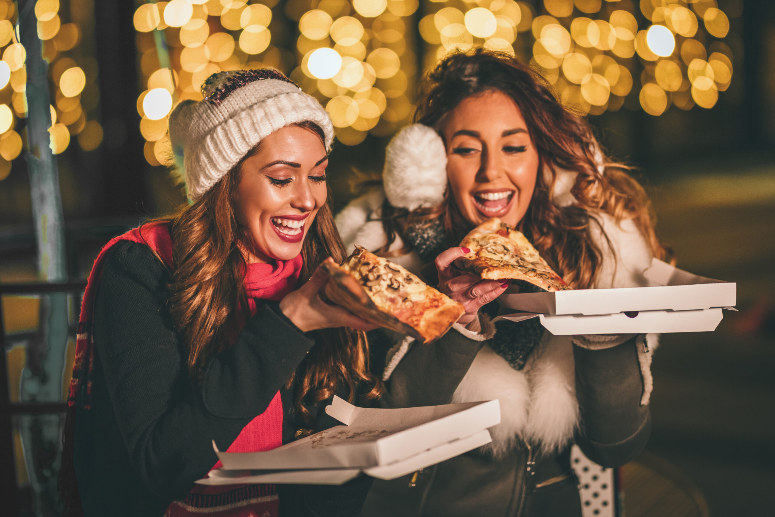 Scraping melted Raclette over meat and potatoes