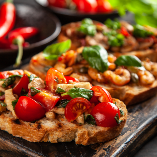Cooking Classes 3 Colorful tomato and herb bruschetta on a wood plank.