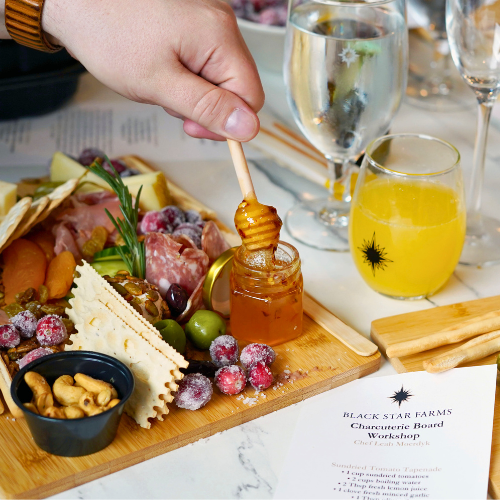 Charcuterie Board Workshop Finished charcuterie board from a past workshop with a mimosa.