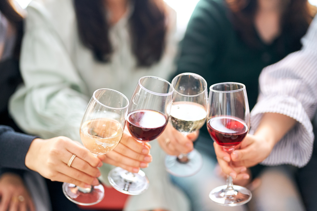 Happy Hour at the Tasting Rooms 2 People toasting with glasses of wine.