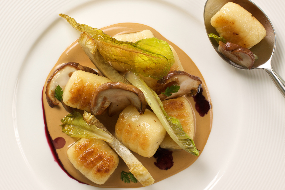 Dining 3 Mushroom gnocchi artfully arranged on a plate