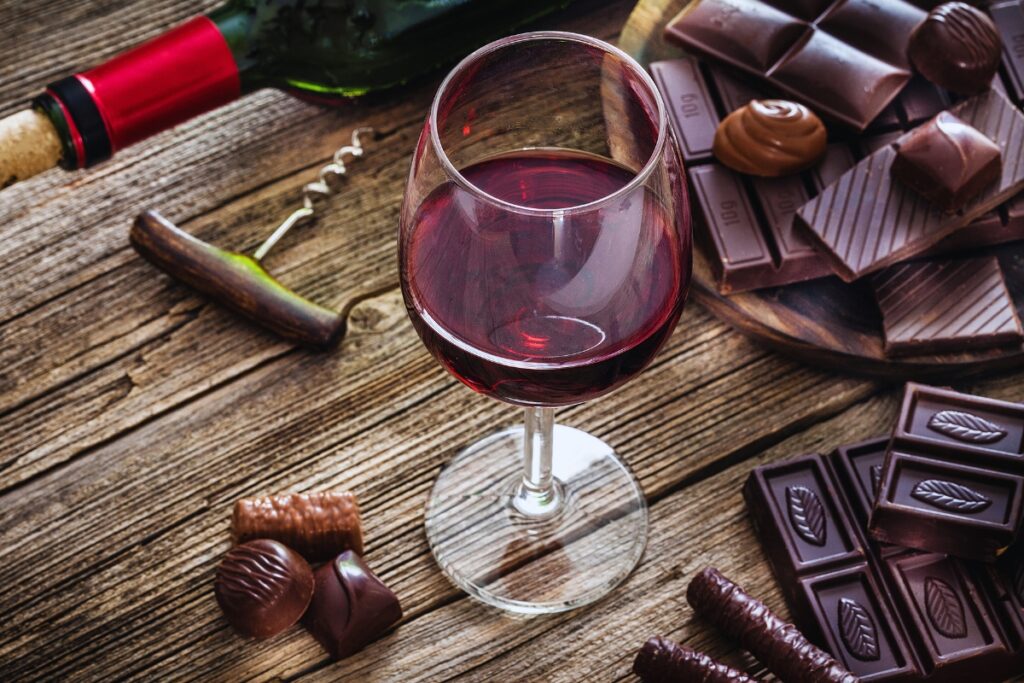 Wine & Chocolate Tasting Workshop 3 A glass of red wine with samples of different chocolates