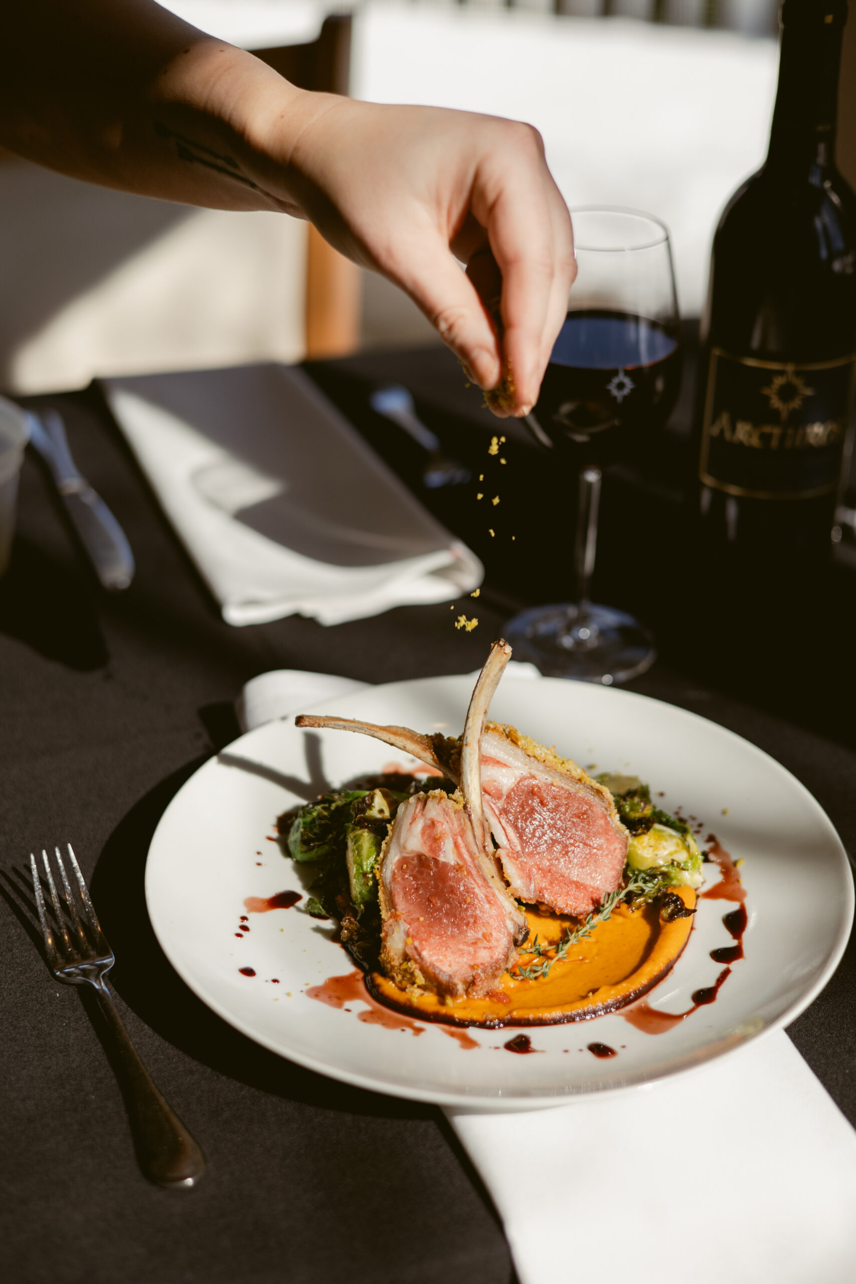 Plated entree with spring flowers on the table.